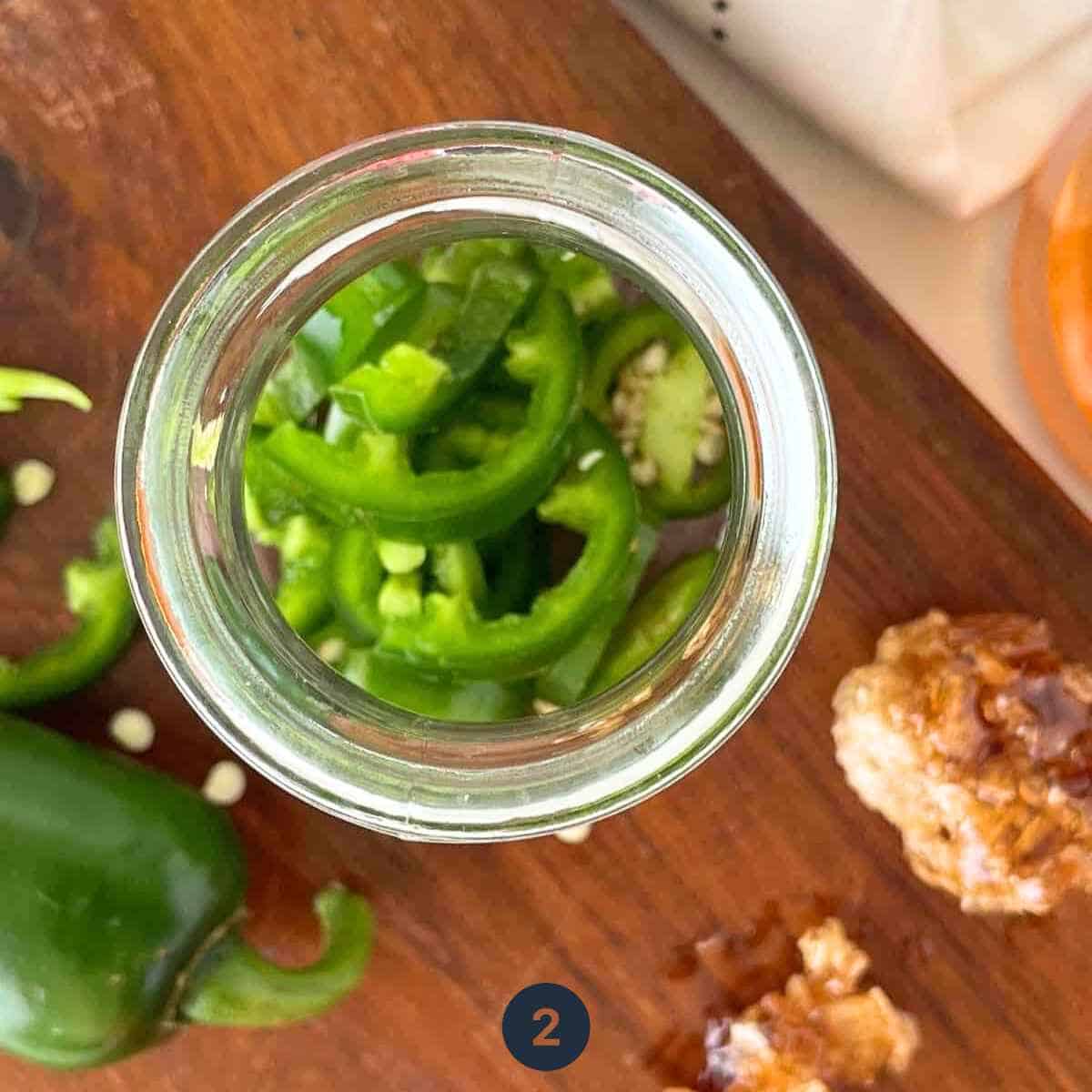 transfer sliced Jalapeno into a container