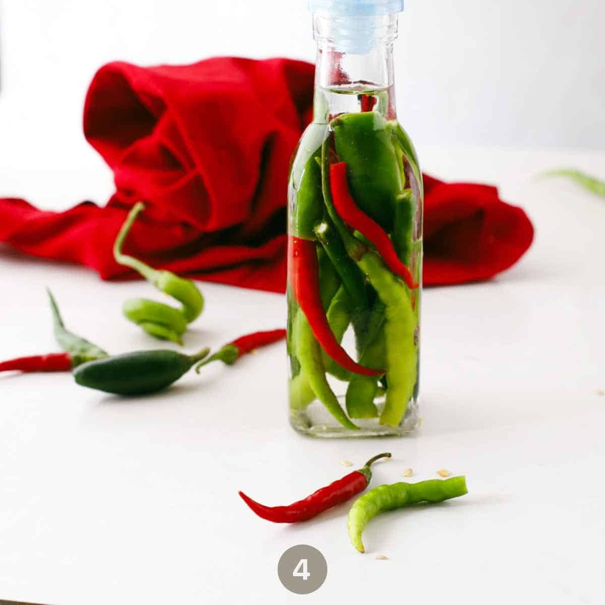 Side view of Hot Pepper Vinegar in  a jar