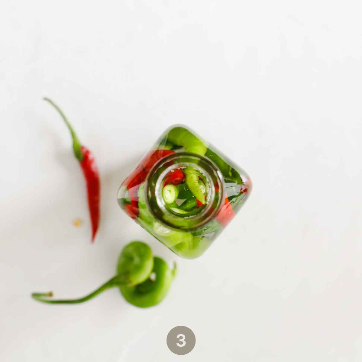 Transfer the peppers pieces into the jar and fill it with hot vinegar