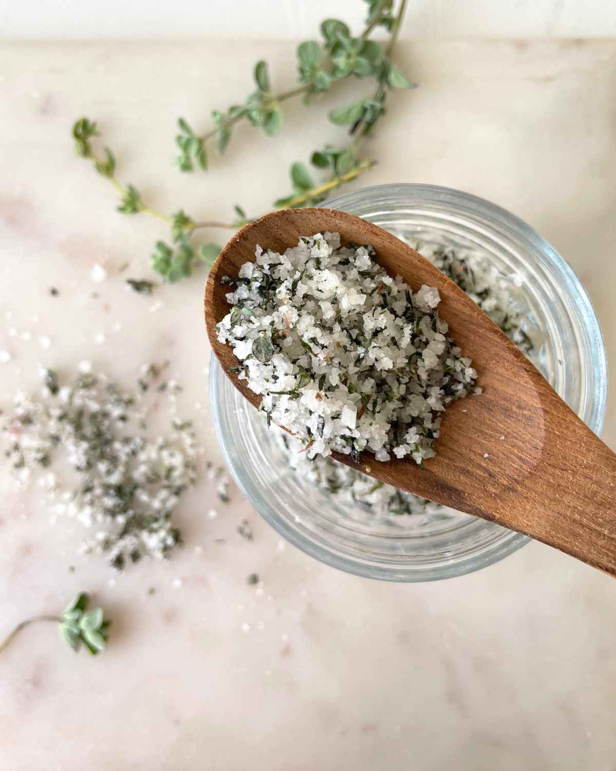 Top view image of Homemade Herb Salt taken in wooden spoon over a jar 