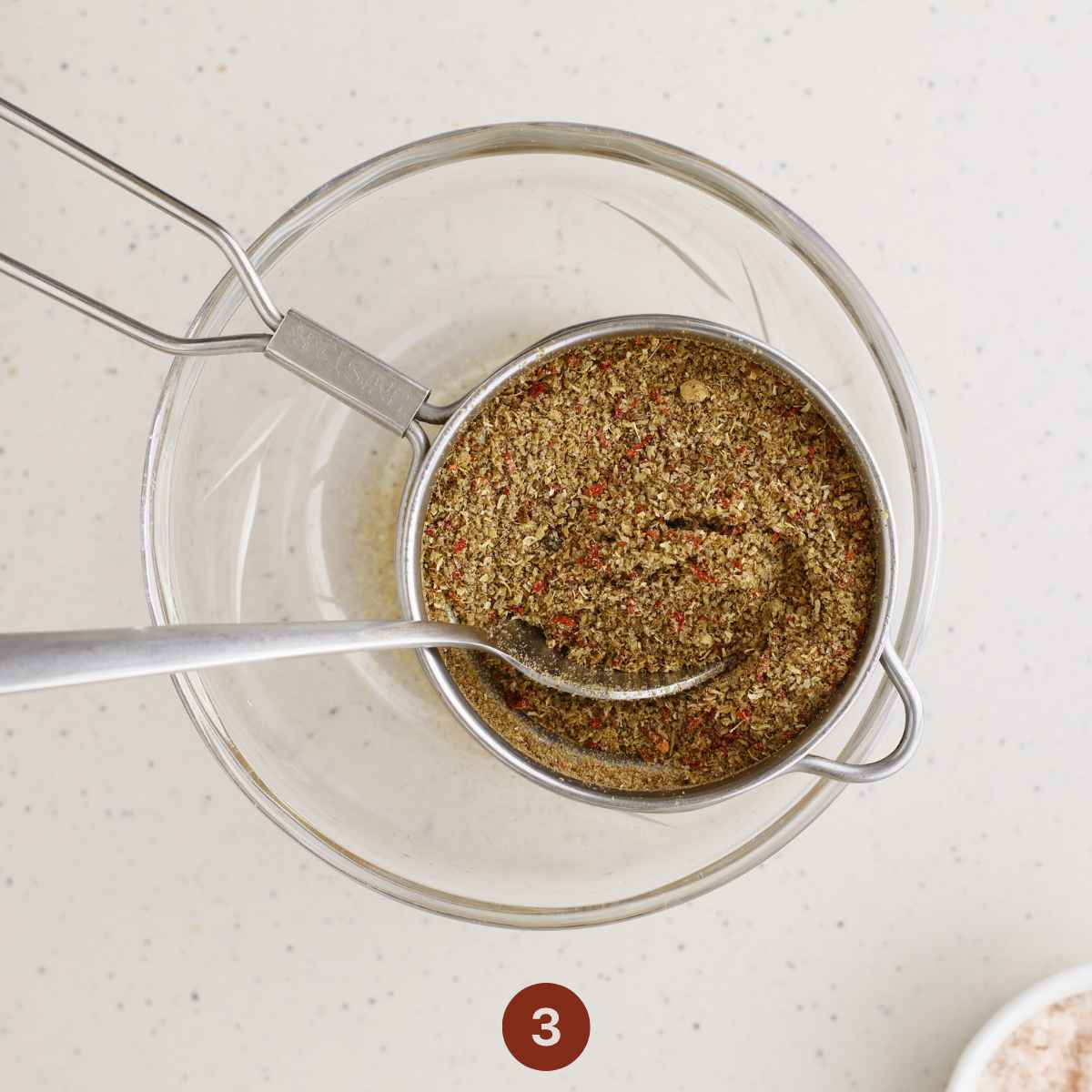 Run the slightly coarse spice mix through a sieve to remove any large chunks.