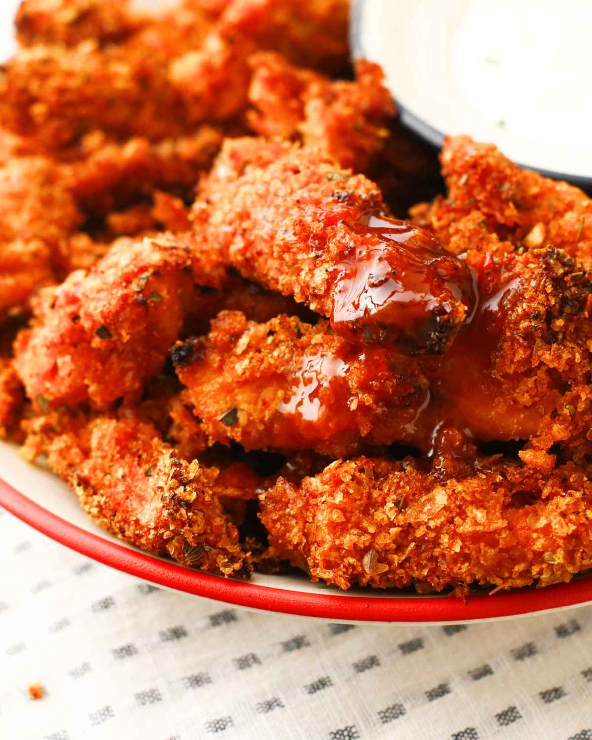 Juicy Air Fried Chicken Tenders on a plate with some ketchup