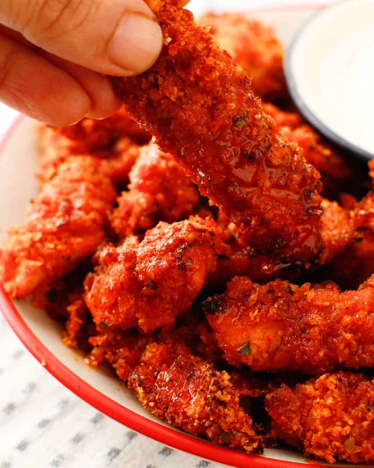 Delicious Air Fryer Buffalo Chicken Tenders in fingers