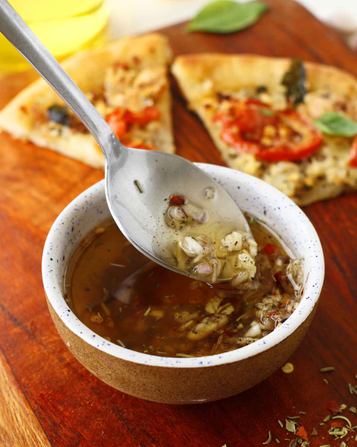 Fresh Olive Oil Pizza Sauce in spoon taken from the bowl